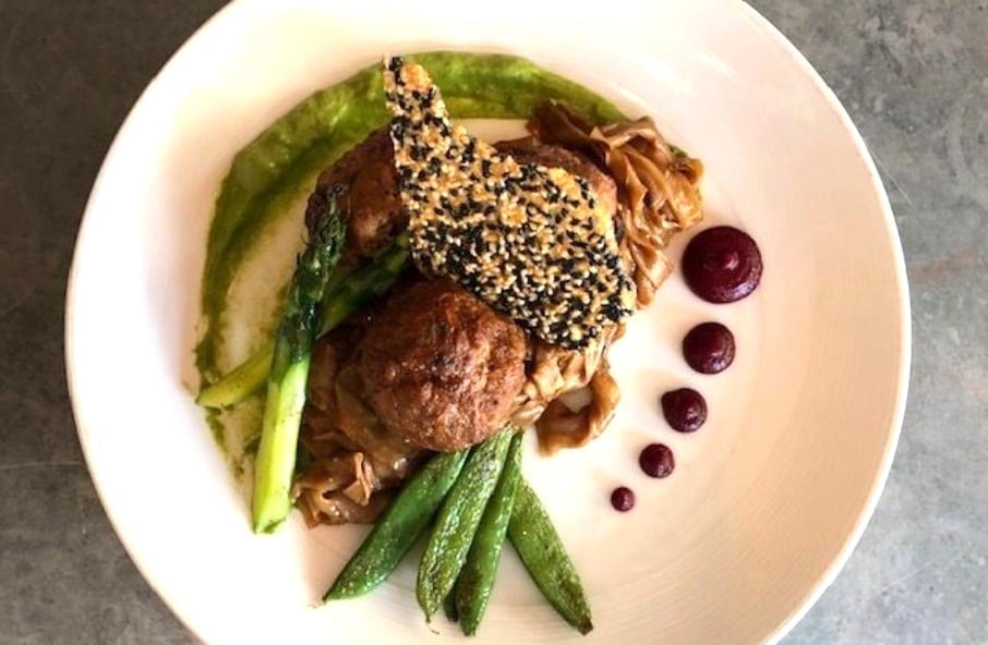 Veal & shiitake meatballs: black garlic noodles, charred scallion miso purée, beet ginger sauce, asparagus, snap peas, honey sesame crisp